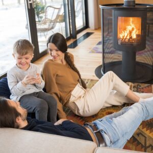 family sitting in front of wood stove