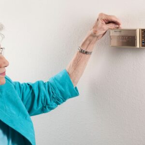 Woman altering thermostat