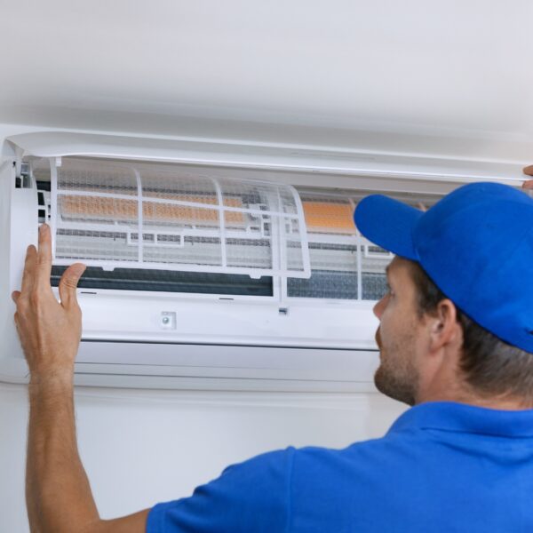 Technician opening up AC vent