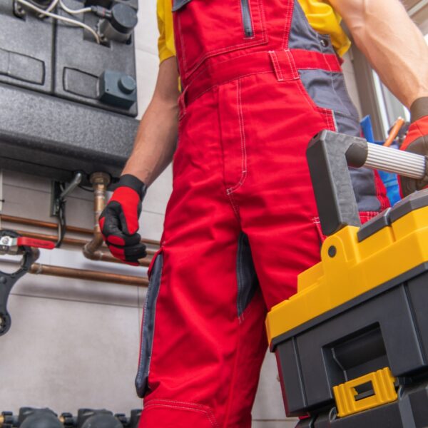 Technician in red overalls